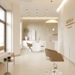 Jasne wnętrze salonu kosmetycznego z krzesłem fryzjerskim, stolikiem kawowym i stanowiskiem do manicure. Minimalistyczny design, ciepłe oświetlenie, estetyka.