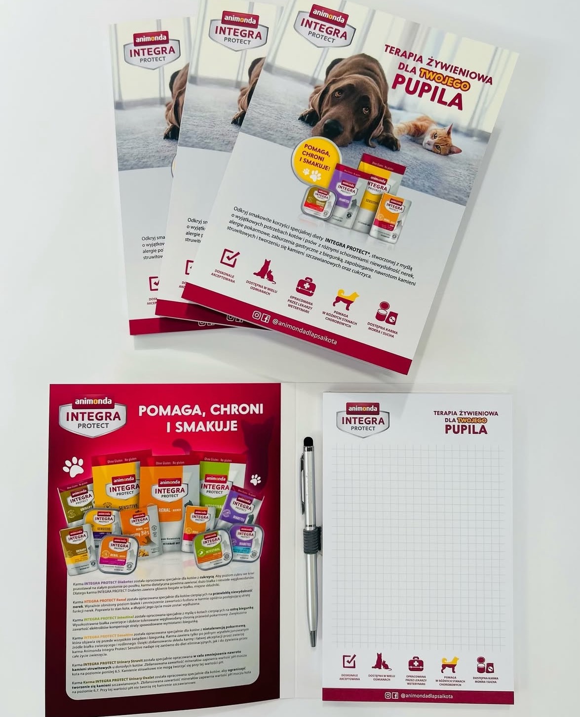 Zestaw materiałów reklamowych Animonda Integra Protect: ulotki, notatnik i długopis. Produkty dla terapii żywieniowej psów i kotów, karma sucha i mokra.