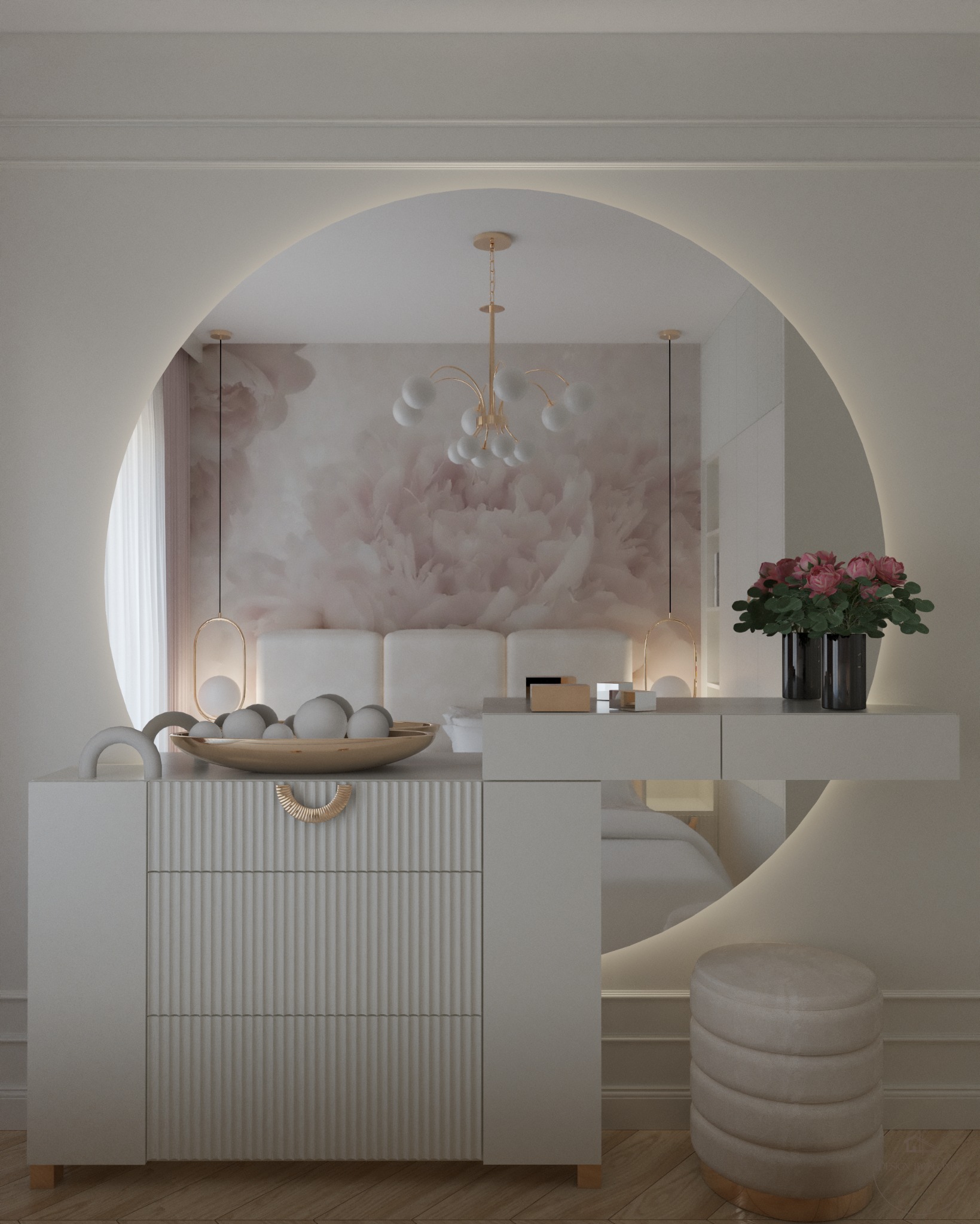 Elegancka sypialnia w jasnych barwach. Toaletka z okrągłym lustrem podświetlonym LED. Na blacie kwiaty w czarnym wazonie, na komodzie dekoracyjna misa z kulami.