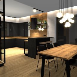 Aranżacje wnętrz Agnieszka Skarżyńska - Wizualizacja nowoczesnej kuchni z czarnymi szafkami, drewnianym blatem i stołem jadalnym. Oświetlenie punktowe i wiszące lampy kuliste. Aranżacja z roślinami na półkach.