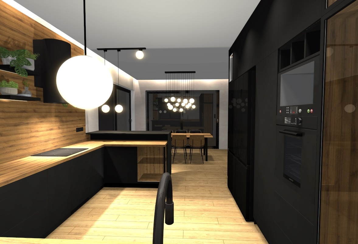 Wnętrze kuchni z drewnianymi akcentami i czarnymi szafkami, oświetlone wiszącymi lampami. W tle widoczny stół z krzesłami, tworzący spójną przestrzeń.
