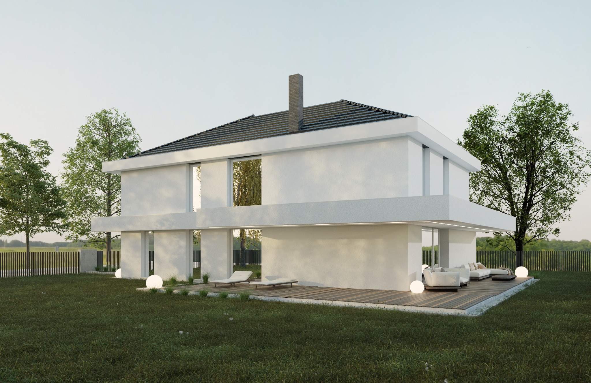 Dwukondygnacyjny, biały dom z płaskim dachem i dużymi oknami, otoczony trawnikiem, drzewami i drewnianym tarasem z meblami wypoczynkowymi oraz kulistymi lampami.