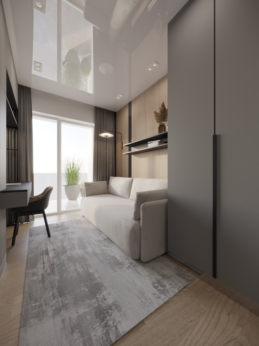 Jasny pokój z sofą, biurkiem i dużym oknem. Minimalistyczny design, drewniana podłoga i szary dywan. W tle widoczna roślina doniczkowa.