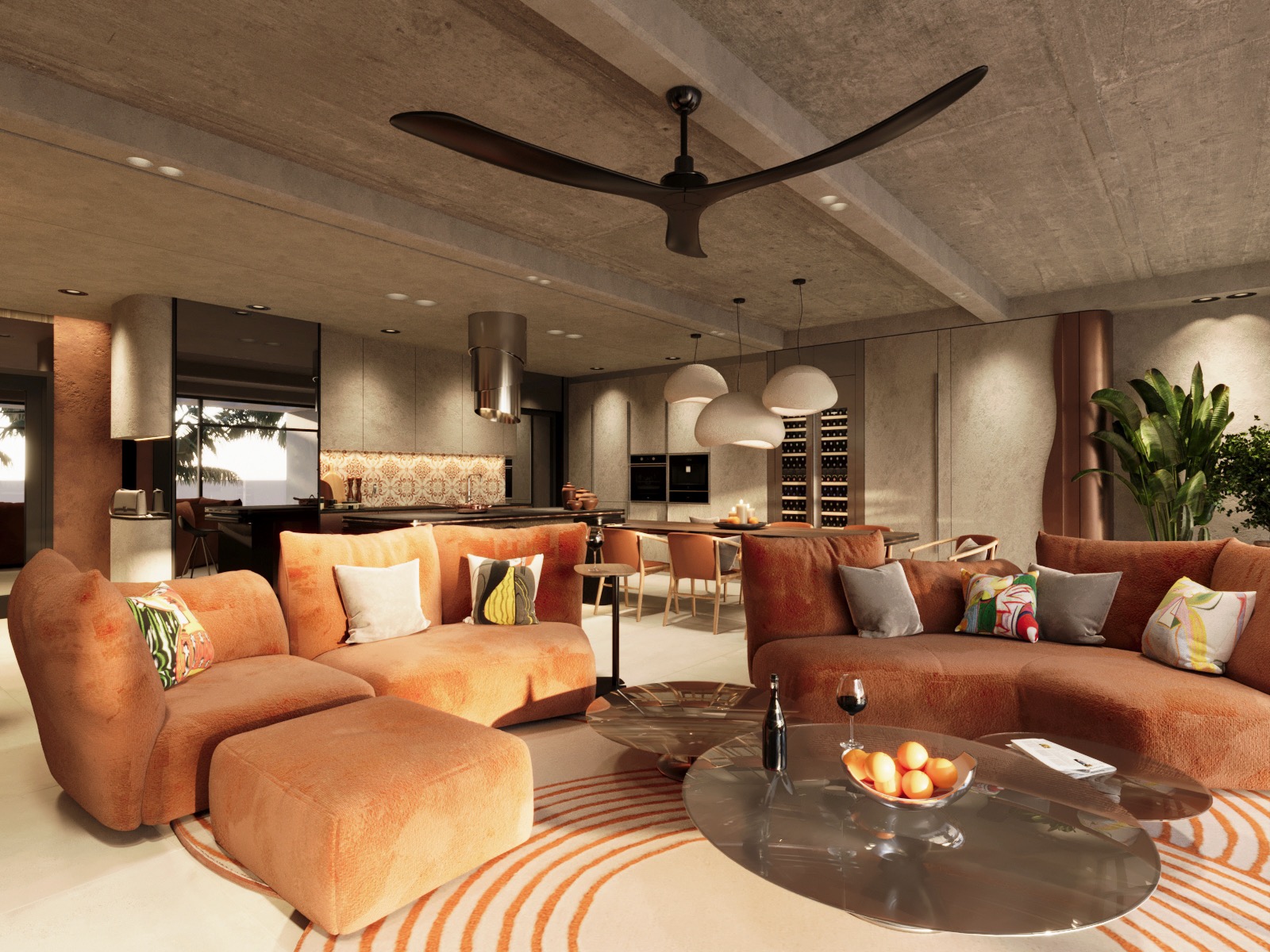 Nowoczesny salon z pomarańczowymi sofami i otwartą kuchnią. Widoczne elementy dekoracyjne, oświetlenie i duży wentylator sufitowy. Minimalistyczny design z akcentami kolorystycznymi.