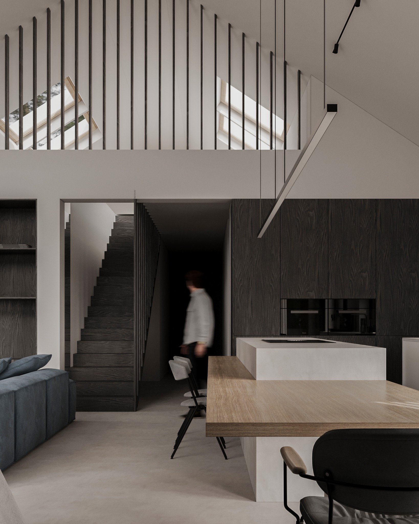 Nowoczesne wnętrze domu z otwartą przestrzenią: schody z drewnianymi barierkami, kuchnia z wyspą i drewnianym blatem, minimalistyczne oświetlenie.