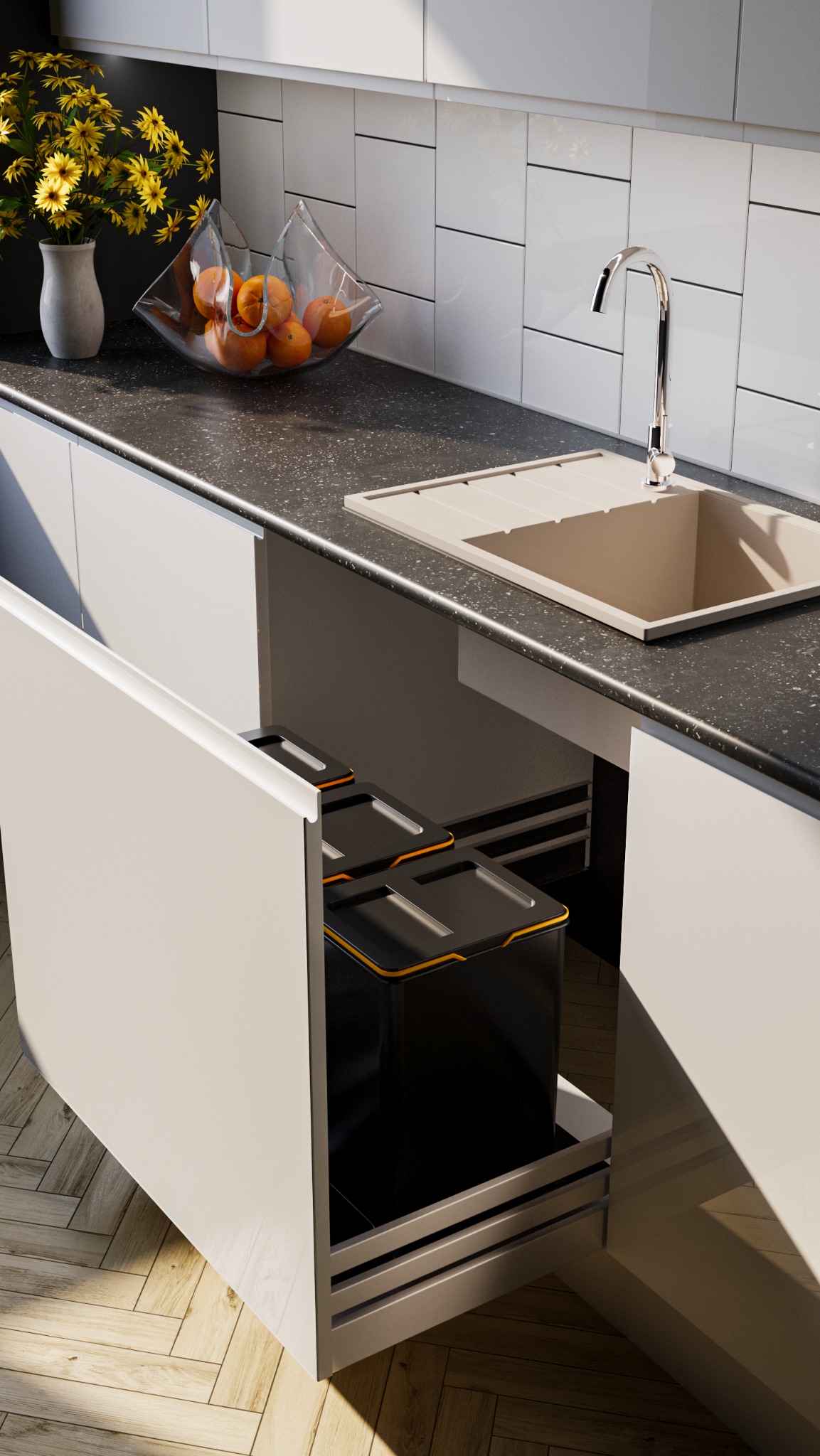 Nowoczesna kuchnia: białe szafki z otwartą szufladą, w której widoczne są pojemniki na odpady. Na blacie kwiaty, owoce i beżowy zlew.