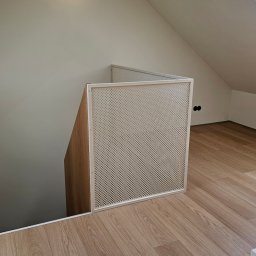 PRO GRAPHIC Jacek Siemiec - Barierka z siatki perforowanej i profili stalowych, zabezpieczająca schody na poddaszu. Jasne wnętrze, drewnopodobna podłoga, skosy.