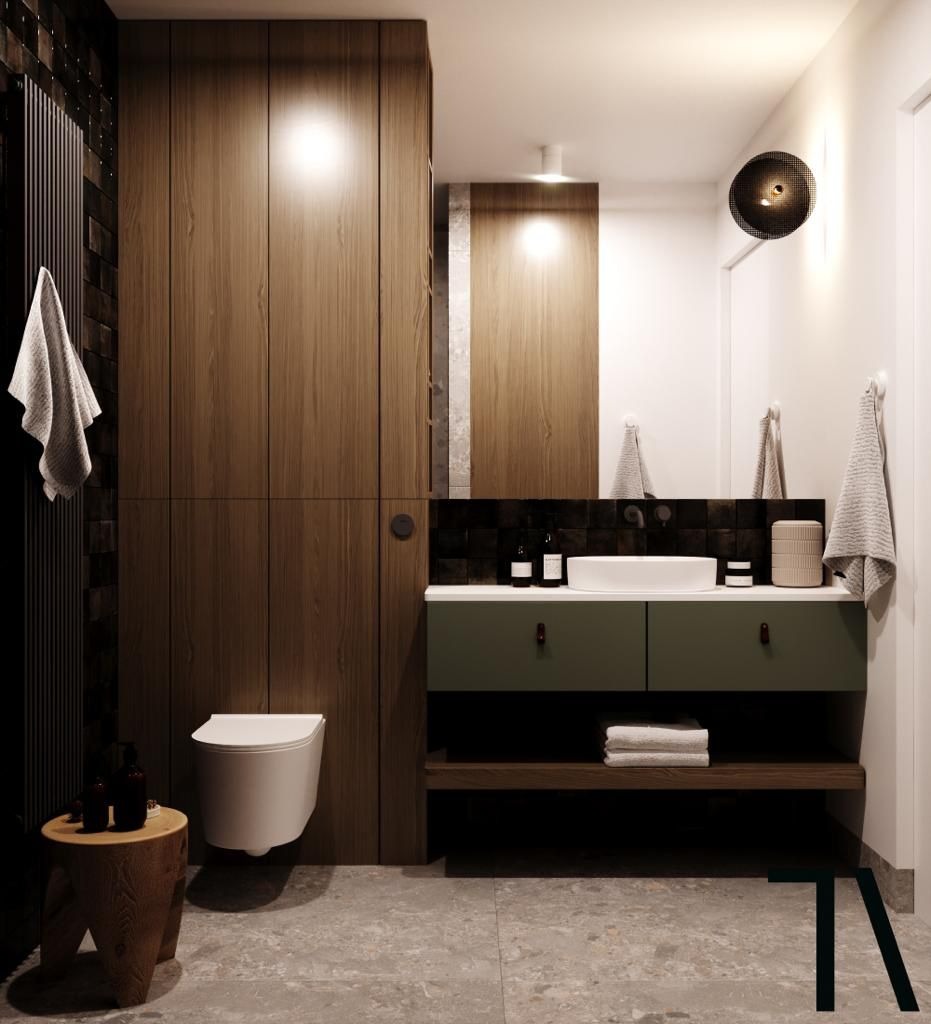 Nowoczesna łazienka z drewnianą zabudową, umywalką nablatową i oryginalnym oświetleniem. Minimalistyczny design z akcentami drewna i zieleni.