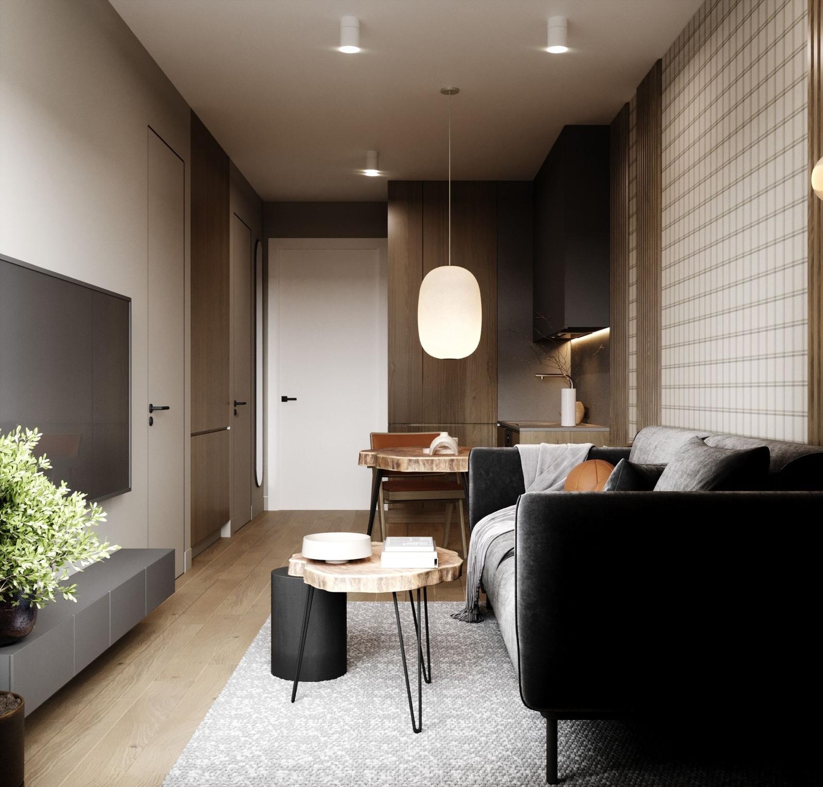 Nowoczesny salon z szarą sofą, drewnianym stolikiem kawowym i podłogą. W tle widoczna jadalnia i kuchnia w stonowanych kolorach, podkreślona designerską lampą.