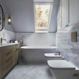 Nowoczesna łazienka na poddaszu z oknem dachowym, białą wanną wolnostojącą, bidetem, umywalką z drewnianą szafką i marmurową mozaiką na podłodze. Jasne, stonowane kolory.