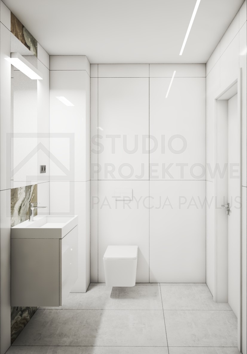 Minimalistyczna łazienka w bieli z umywalką na szafce i toaletą podwieszaną. Akcent marmuru przy umywalce. Oświetlenie liniowe LED na suficie.