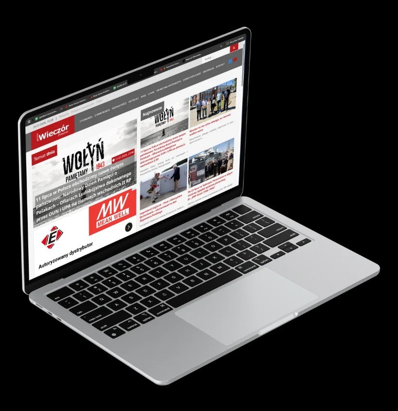 Laptop z otwartą stroną internetową, wyświetlającą artykuły informacyjne. Widoczny ekran, klawiatura i touchpad na czarnym tle.