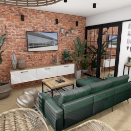 Rokosz Design - Salon z ceglaną ścianą i zieloną sofą w Sandomierzu. Nowoczesny wystrój z roślinami, białymi szafkami i drewnianym stolikiem kawowym.