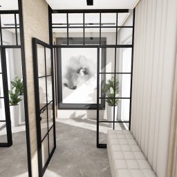 Rokosz Design - Nowoczesny przedpokój z czarnymi, przeszklonymi drzwiami, marmurową podłogą i minimalistycznymi ławkami. W tle obraz w czarnej ramie i rośliny doniczkowe.