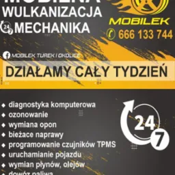 Żółto-czarny baner reklamowy mobilnej wulkanizacji i mechaniki pojazdowej z numerem telefonu, logiem opony z płomieniami i hasłem 'Działamy cały tydzień'.