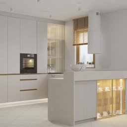 Meble Moras Piotr - Jasna kuchnia na wymiar z wyspą i oświetleniem LED. Fronty szafek gładkie, matowe. Na wyspie ekspozycja zastawy stołowej. Minimalistyczny design.