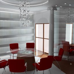 Mirosław Wesołowski - Nowoczesna sala konferencyjna z okrągłym stołem, czerwonymi krzesłami i dekoracyjnym żyrandolem. Widoczne biurko z komputerem w tle.