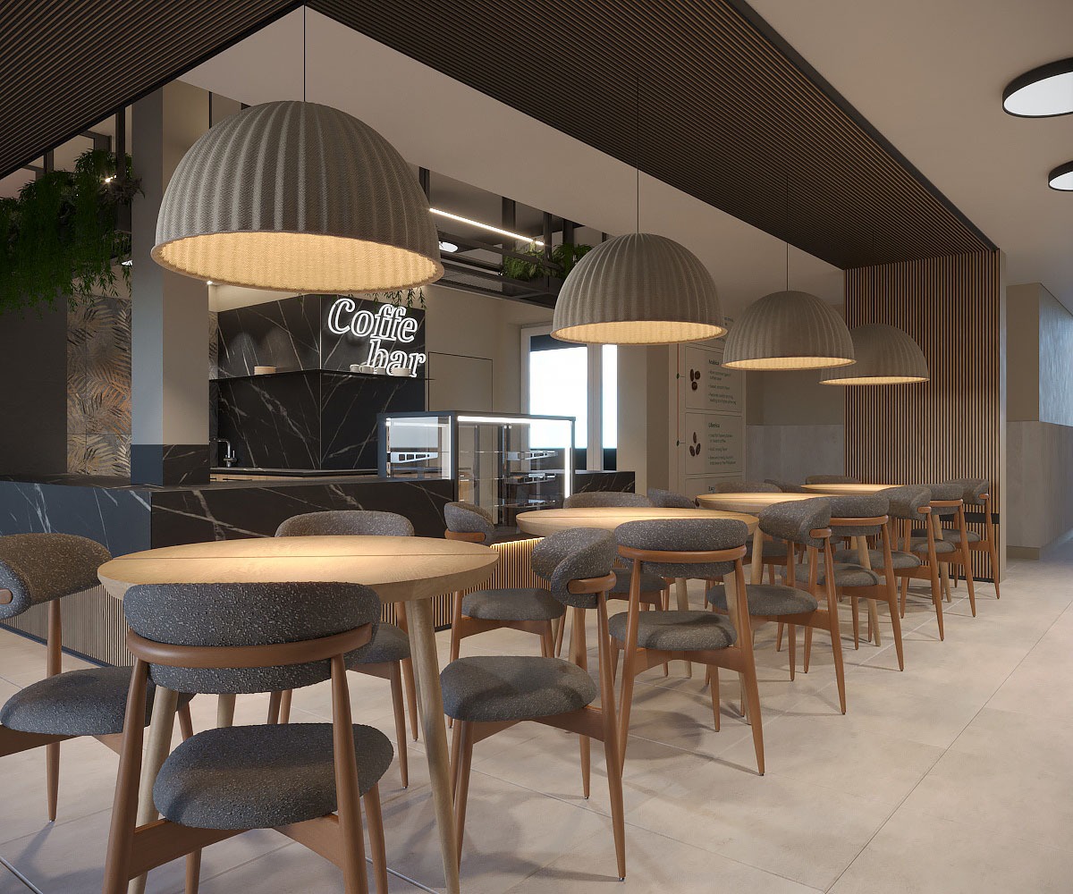 Wnętrze kawiarni z okrągłymi stolikami i szarymi krzesłami, oświetlone wiszącymi lampami w kształcie kopuł. W tle marmurowy bar z neonowym napisem 'Coffee bar'.