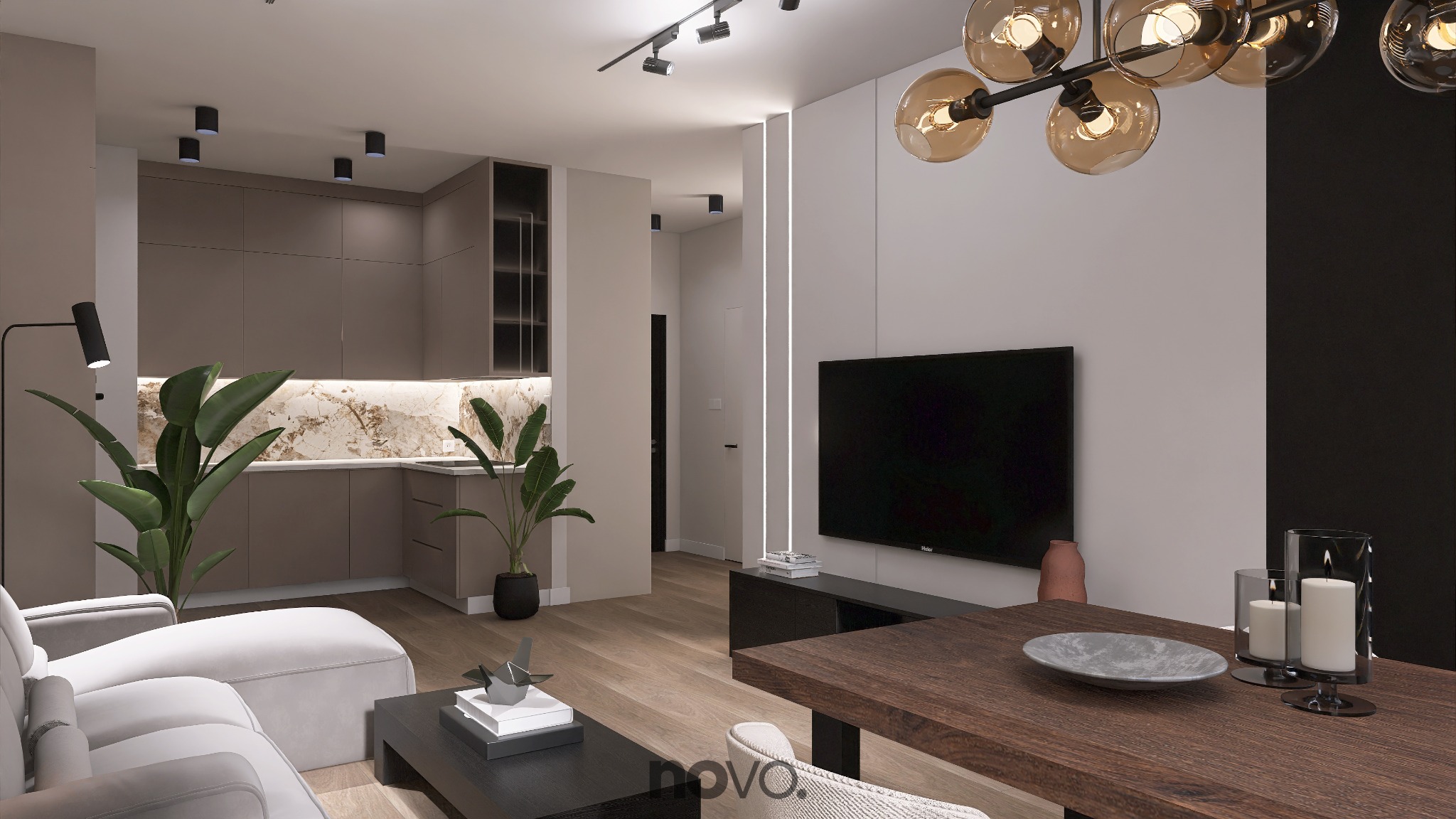 Nowoczesne wnętrze: salon z aneksem kuchennym w stonowanych barwach. Drewniany stół, szara sofa, rośliny doniczkowe i designerska lampa tworzą spójną całość.