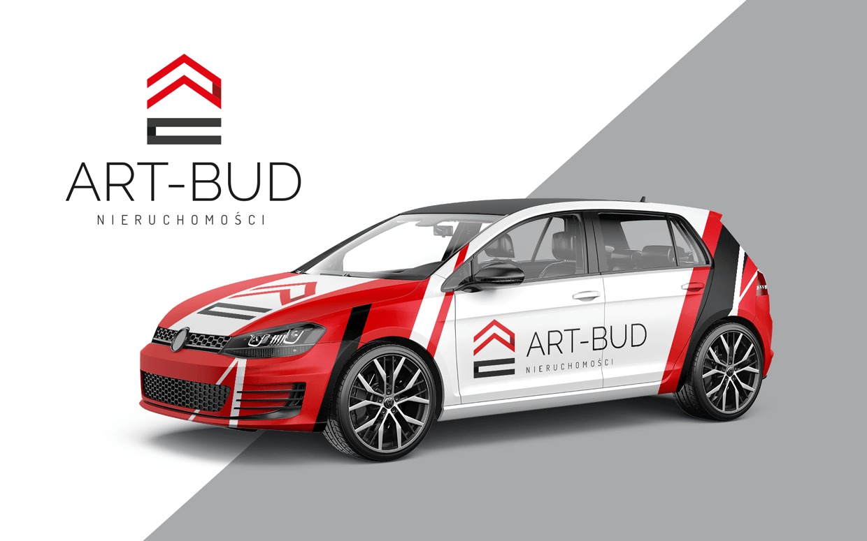 Grafika prezentuje samochód z brandingiem firmy ART-BUD Nieruchomości. Dominuje biel, czerwień i czerń. Logo firmy umieszczone na karoserii. Efektowny design.