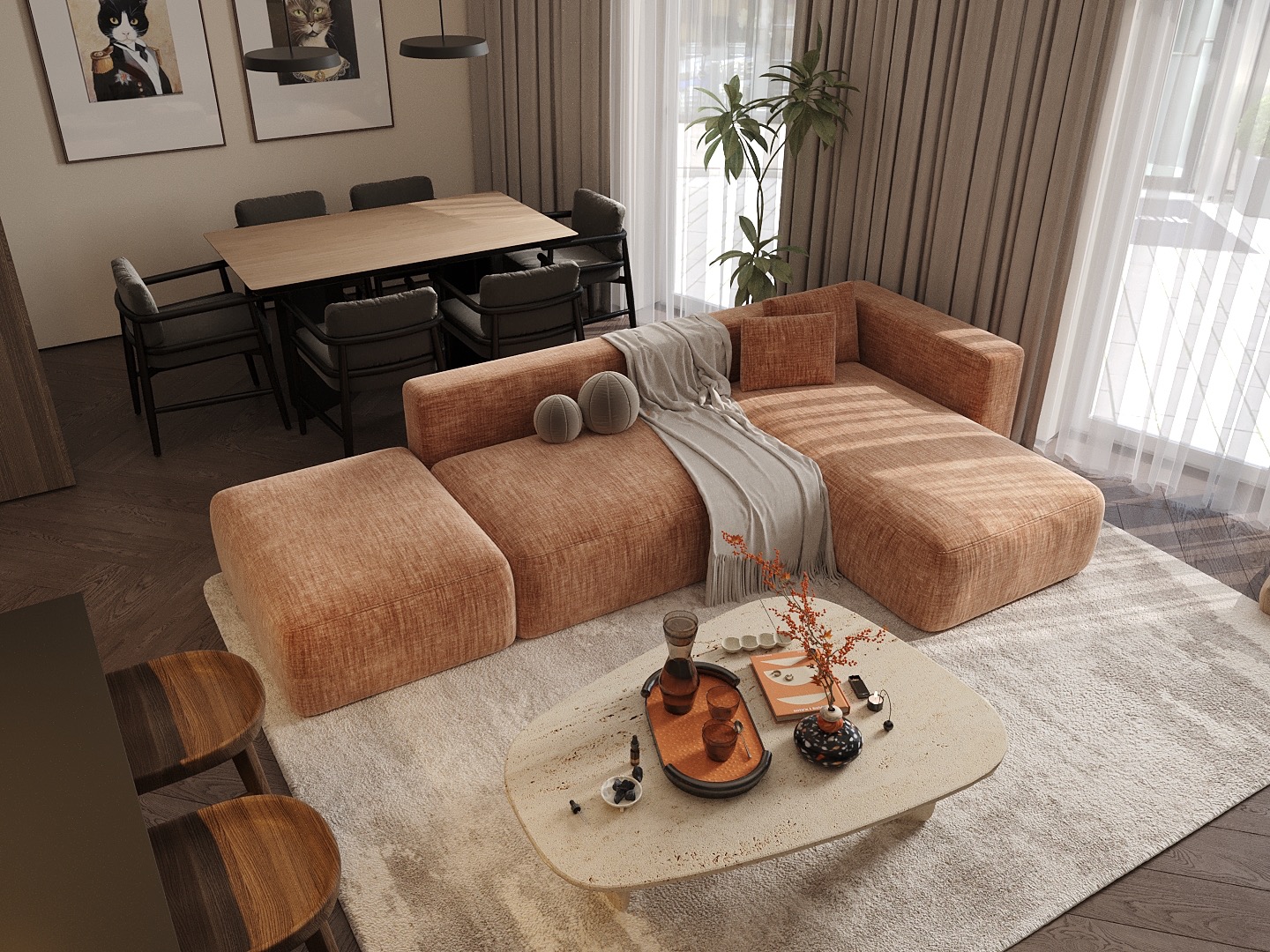 Jasne, przestronne wnętrze: sofa z otomaną, stół z krzesłami, stolik kawowy z dekoracjami. Uwagę przykuwają grafiki z kotami w stylu retro i naturalne światło.