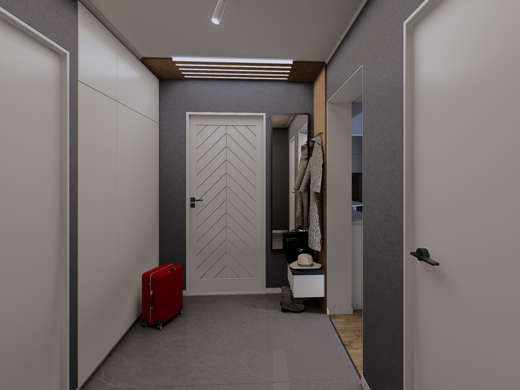 Nowoczesny przedpokój z szafą w zabudowie, lustrem, wieszakiem i siedziskiem. Czerwona walizka dodaje koloru szarej aranżacji. Oświetlenie sufitowe podkreśla design.