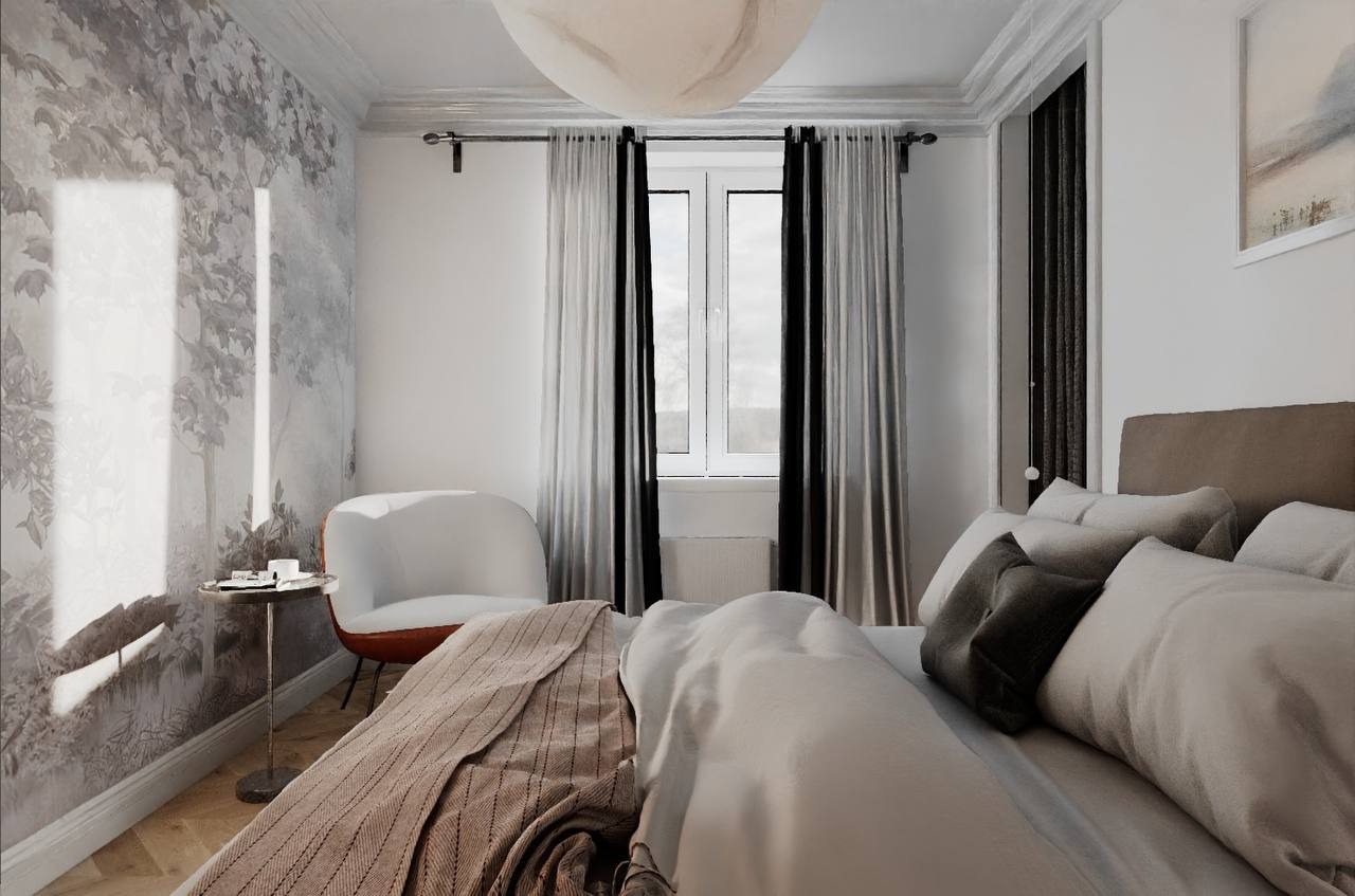 Jasna sypialnia z fototapetą w motywy roślinne, białe zasłony z czarnymi pasami, designerski fotel i lampa sufitowa. Przytulne wnętrze.