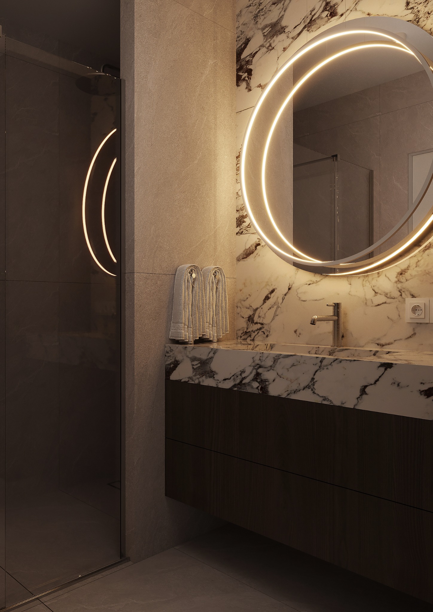 Nowoczesna łazienka z marmurową umywalką, okrągłym lustrem z podświetleniem LED i kabiną prysznicową. Minimalistyczny design w stonowanej kolorystyce.