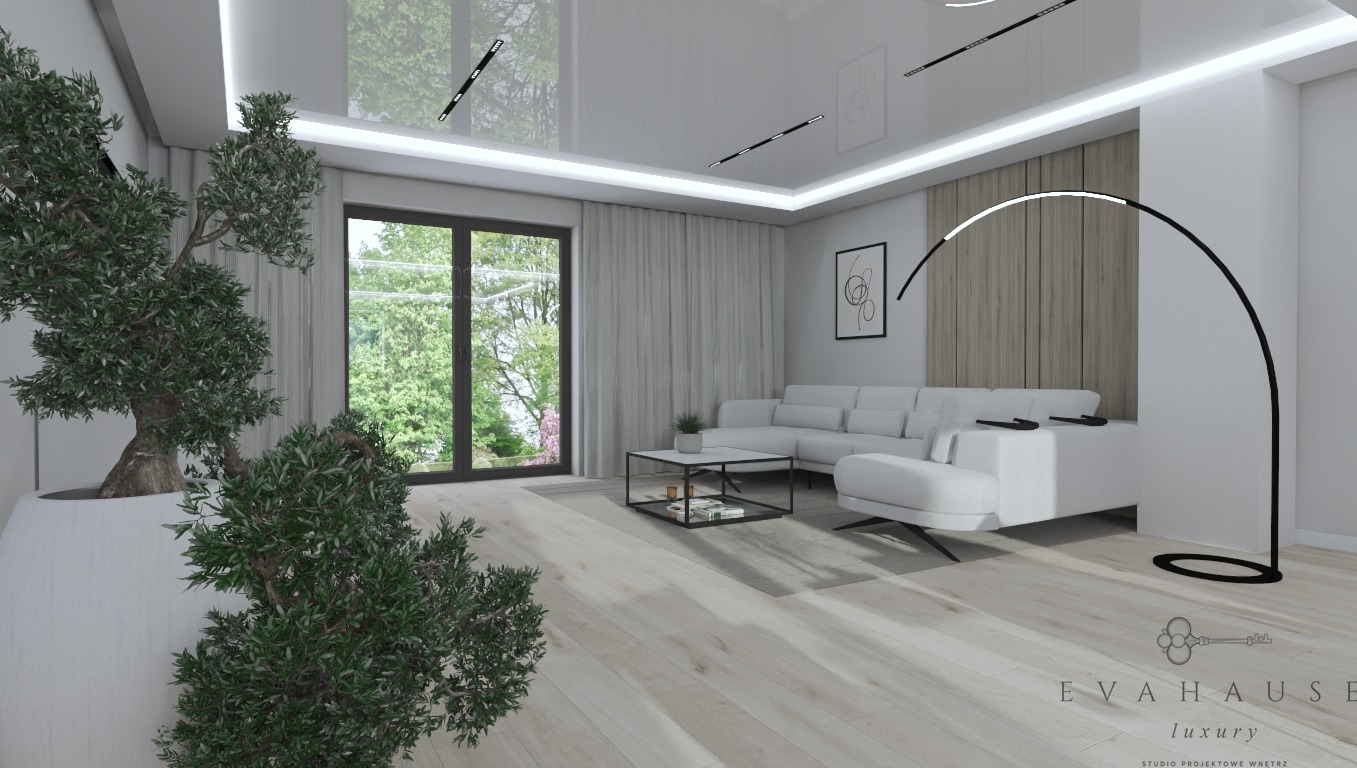 Jasne wnętrze salonu z białym narożnikiem, lampą łukową i dużym oknem z widokiem na zieleń. W rogu donica z drzewkiem. Minimalistyczny design z akcentami natury.