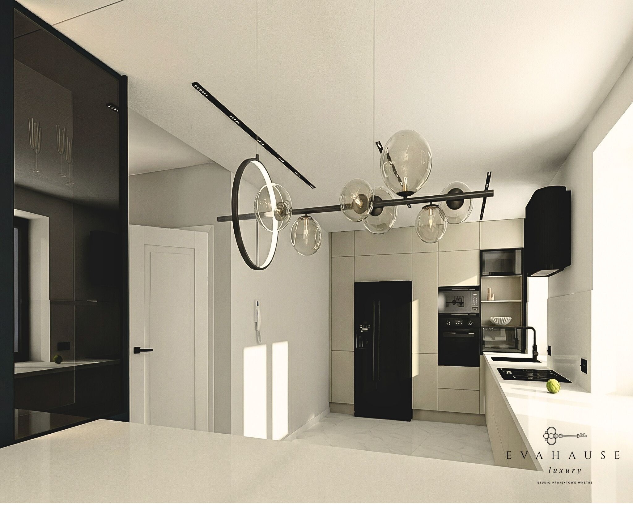 Nowoczesna kuchnia w odcieniach beżu i czerni z designerską lampą sufitową. Minimalistyczne fronty szafek i sprzęt AGD w czarnym kolorze. Widoczny fragment blatu.