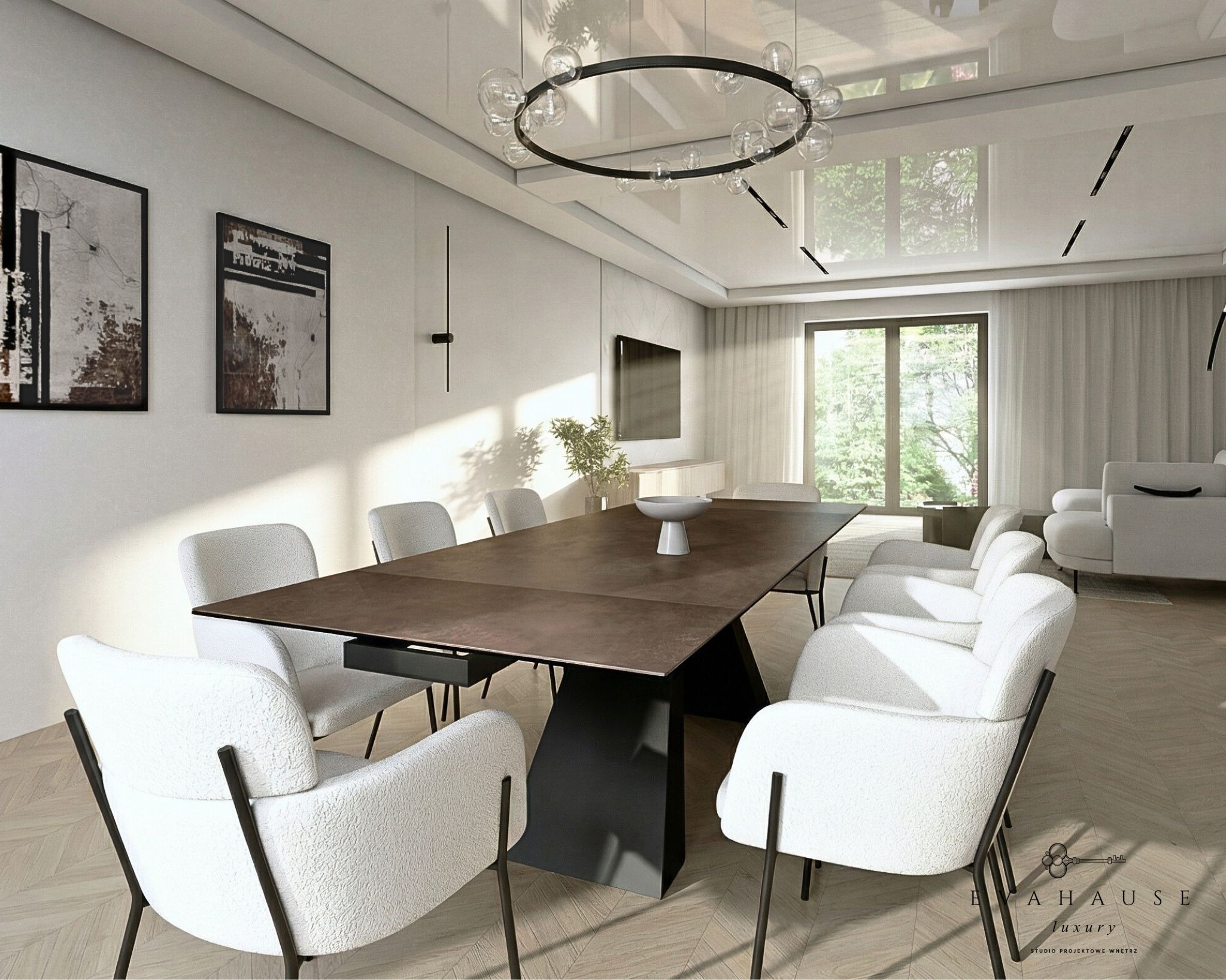 Nowoczesna jadalnia z dużym stołem i białymi krzesłami. Minimalistyczny design, okrągły żyrandol i jasne wnętrze z parkietem w jodełkę. Dwa obrazy na ścianie.