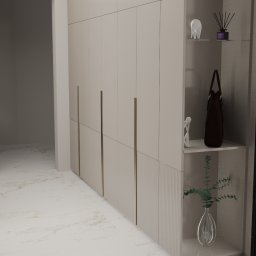 Projektowanie wnętrz Anna Żyjewska-Bas - Beżowa szafa wnękowa z ryflowanym dołem, półki z dekoracjami, marmurowa podłoga i czarna rama drzwi w nowoczesnym wnętrzu.