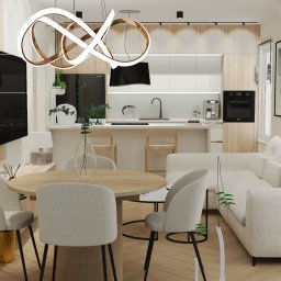 Projektowanie wnętrz Anna Żyjewska-Bas - Nowoczesne wnętrze: jasna kuchnia z drewnianymi akcentami, okrągły stół jadalny i narożna sofa. Całość oświetlona designerską lampą wiszącą.
