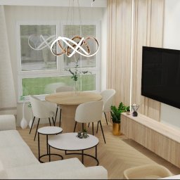 Projektowanie wnętrz Anna Żyjewska-Bas - Jasne wnętrze: sofa, okrągły stół z krzesłami, telewizor na ścianie, nowoczesna lampa wisząca. Minimalistyczny design z akcentami drewna i bieli. Parkiet w jodełkę.