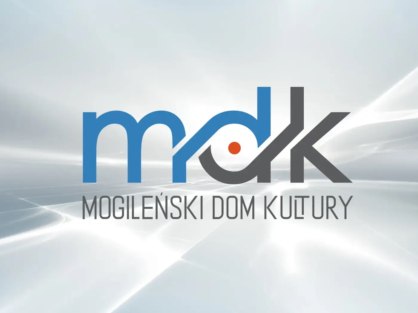 Profesjonalne logo Mogileńskiego Domu Kultury (MDK) na abstrakcyjnym, jasnym tle. Litery 'mdk' w kolorach niebieskim i szarym z pomarańczowym akcentem.