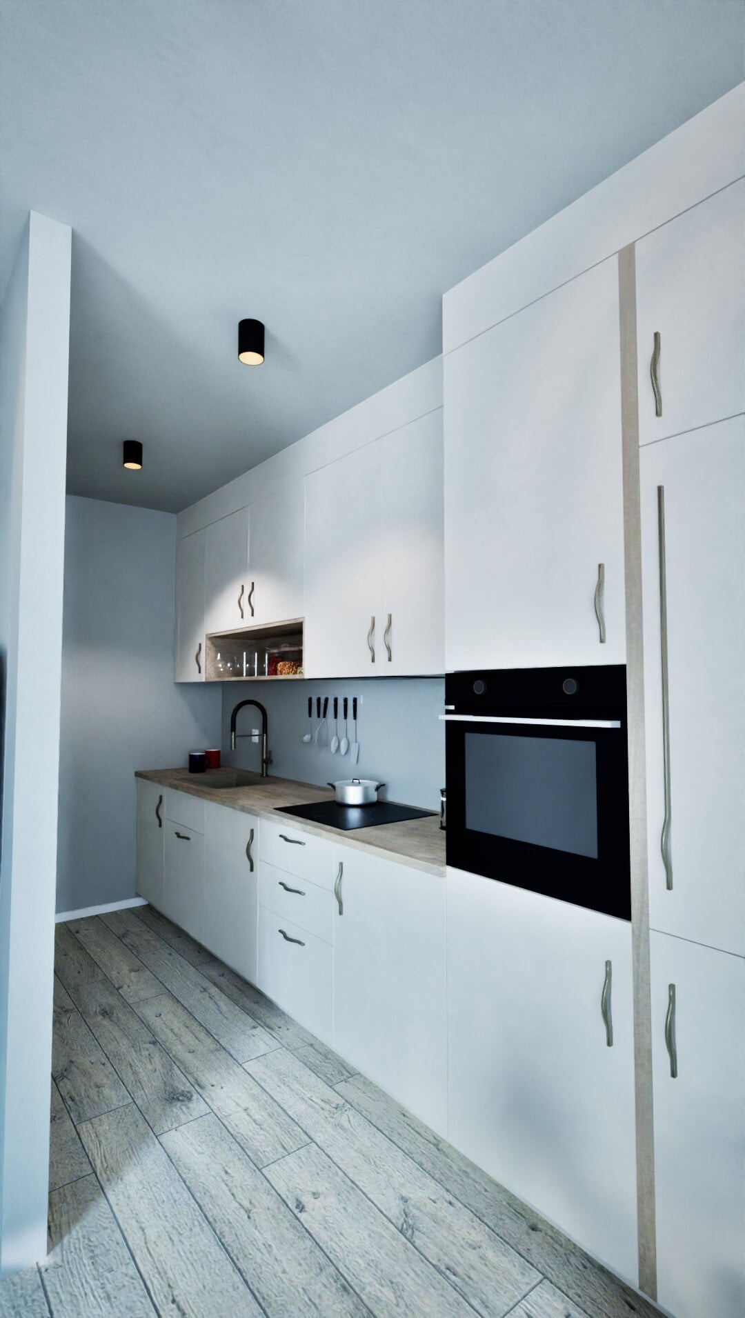 Minimalistyczna kuchnia z białymi szafkami, drewnianym blatem i podłogą. Czarna płyta grzewcza i piekarnik w zabudowie. Nowoczesne oświetlenie punktowe.
