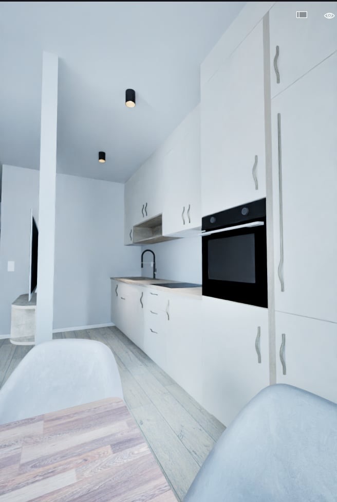 Minimalistyczna, jasna kuchnia z białymi szafkami, czarnym piekarnikiem i drewnianym stołem. Nowoczesne oświetlenie punktowe. Widok z perspektywy siedzącego przy stole.