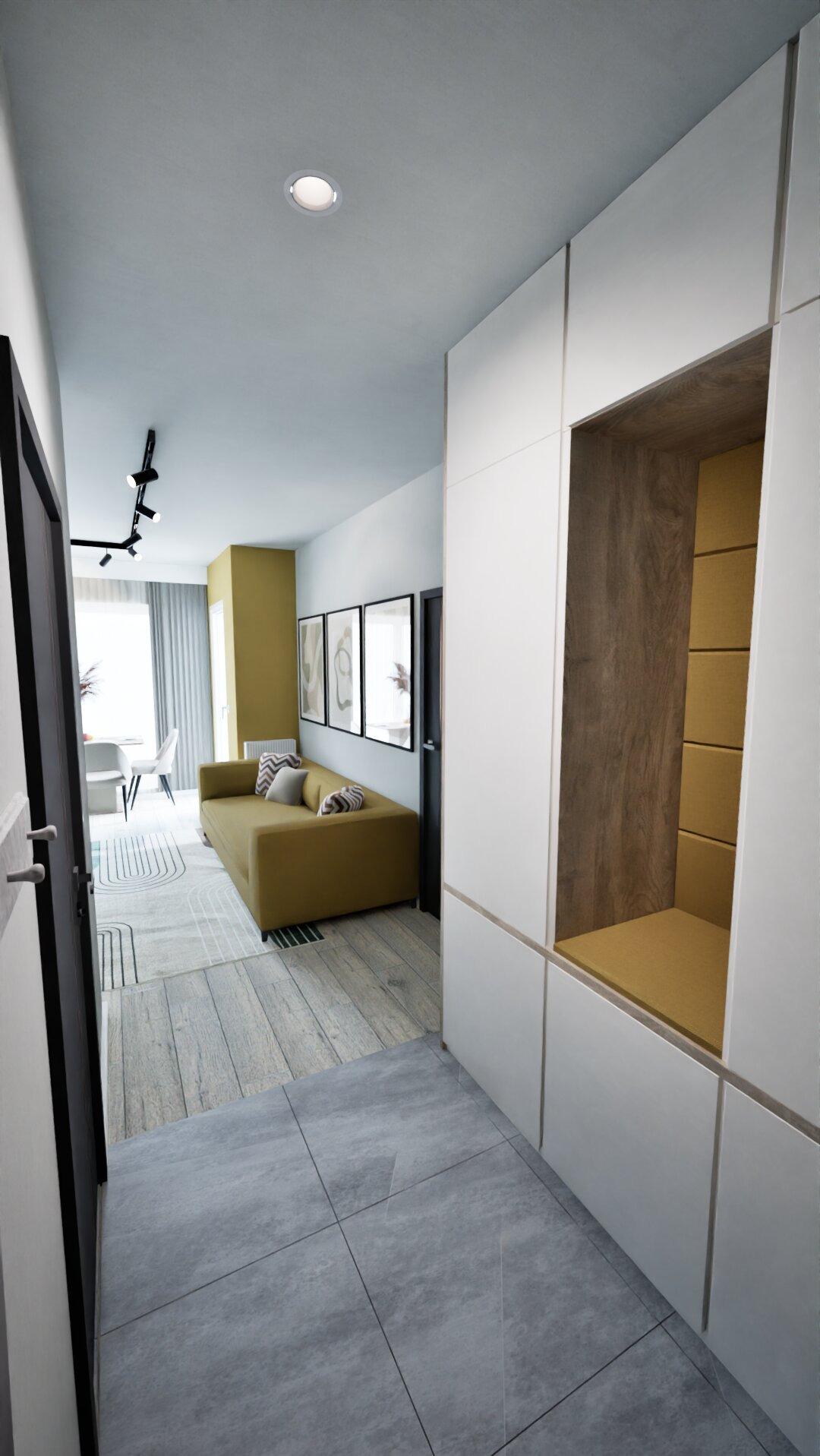 Nowoczesne wnętrze: oliwkowa sofa z poduszkami, grafiki na ścianie, zabudowa z wnęką z siedziskiem, szara podłoga. Minimalistyczny design z akcentami kolorystycznymi.