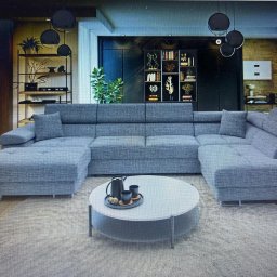 Zakład tapicerski VIOLA - Szary, modułowy narożnik z poduchami i metalowymi nóżkami, na tle nowoczesnego salonu z regałami i okrągłym stolikiem kawowym.