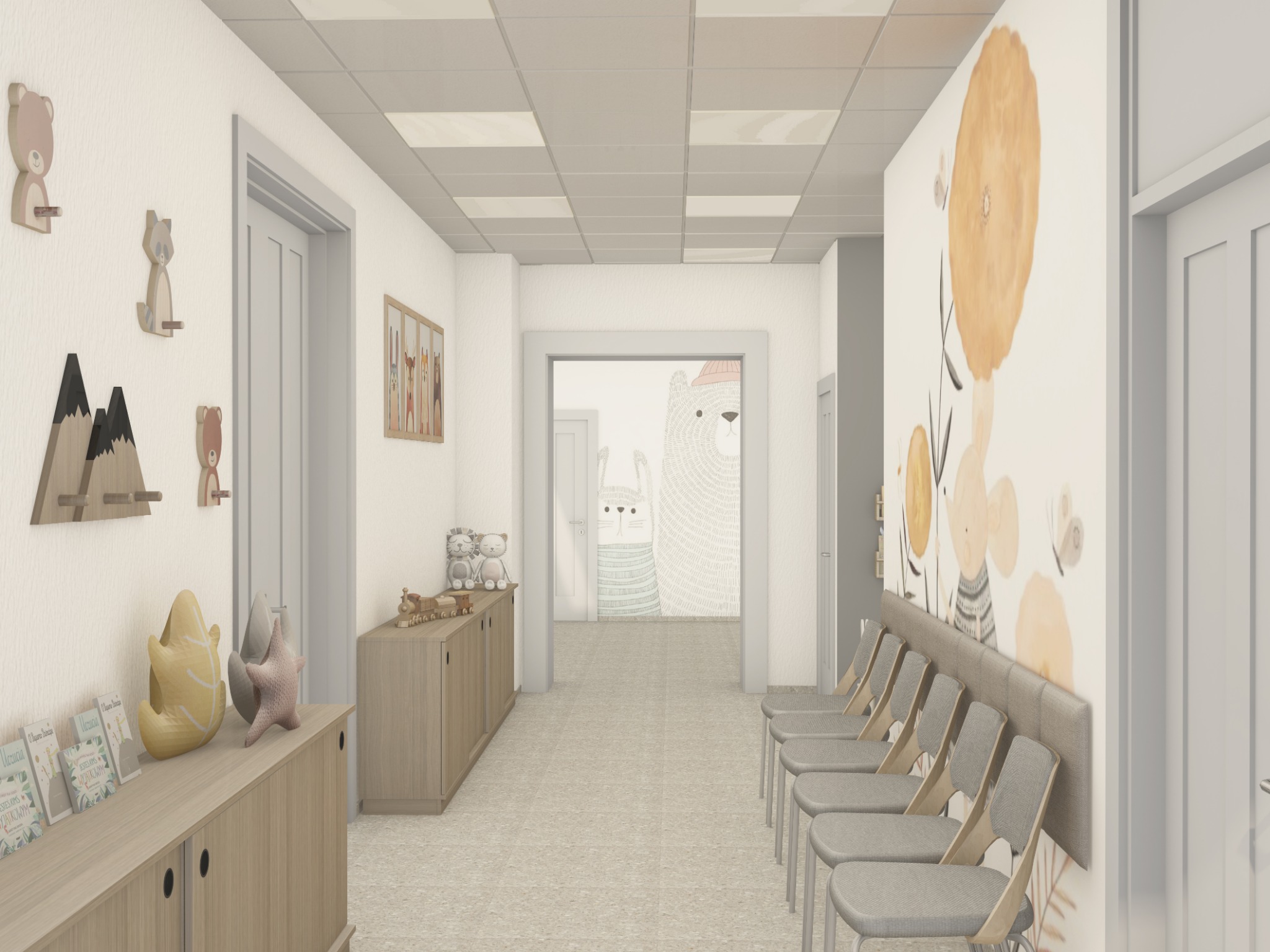 Wnętrze poczekalni z motywami dziecięcymi: drewniane wieszaki, obrazki na ścianach, wygodne krzesła. Jasne, neutralne kolory tworzą przyjazną atmosferę.