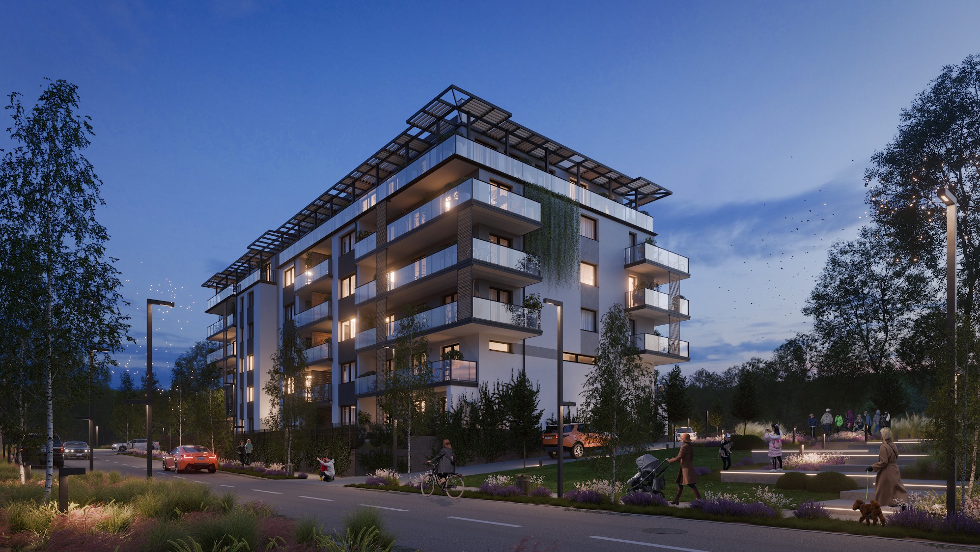 Nowoczesny budynek wielorodzinny z balkonami i szklanymi balustradami oświetlony wieczornym światłem, z elementami zieleni na elewacji i otoczeniu.