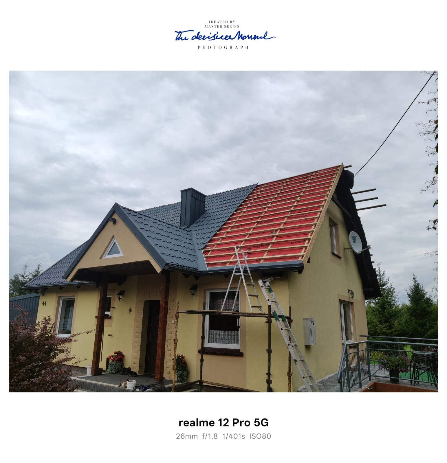 Połowa dachu pokryta szarą dachówką, druga w trakcie prac z łatami w Przywidzu. Na ścianie budynku widoczny numer 44. Metalowa drabina oparta o dach.