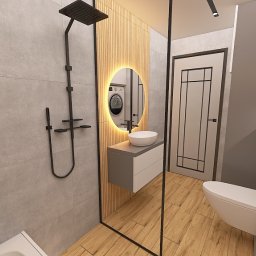 Robert Potoczny - Nowoczesna łazienka z szarą armaturą, drewnianymi akcentami i okrągłym lustrem z podświetleniem LED. Widoczna kabina prysznicowa typu walk-in i wisząca szafka z umywalką.