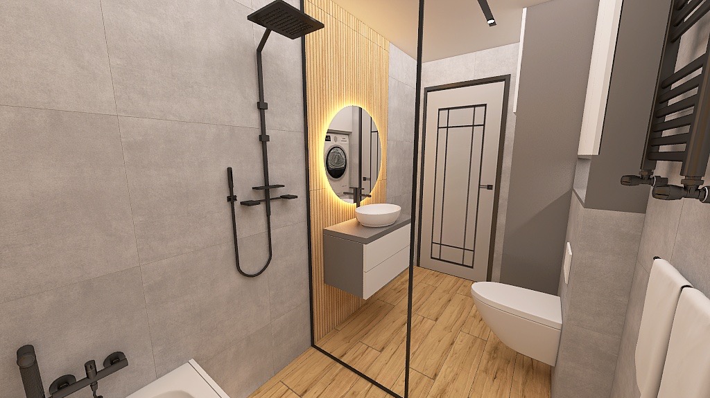Nowoczesna łazienka z szarą armaturą, drewnianymi akcentami i okrągłym lustrem z podświetleniem LED. Widoczna kabina prysznicowa typu walk-in i wisząca szafka z umywalką.