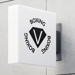 Wiktor Kucharski - Kanciasty szyld z napisem 'BOXING' w czerni, umieszczony na szarej ścianie. Logo w kształcie rombu z literą V w środku. Minimalistyczny design, ostre oświetlenie.