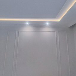 DAMIAN RYBAK - Ściana z dekoracyjnymi panelami i oświetleniem LED w suficie. Minimalistyczny design wnętrza, szara kolorystyka, nowoczesne wykończenie. Dwa punktowe światła.