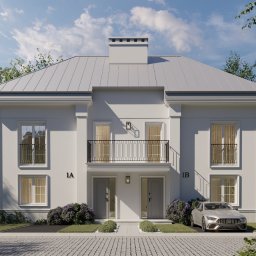 Proli Design Oliwia Pietras - Elewacja dwukondygnacyjnego domu bliźniaczego z balkonem i szarym dachem, z numerami 1A i 1B, otoczona zielenią i brukowanym podjazdem, z zaparkowanym samochodem.