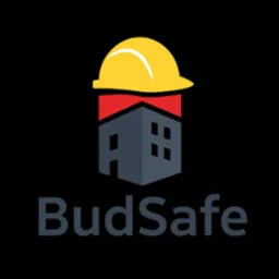 Grafika: Stylizowany budynek z żółtym kaskiem na dachu, logo 'BudSafe' poniżej. Symbolizuje bezpieczeństwo budowlane i ochronę w miejscu pracy.
