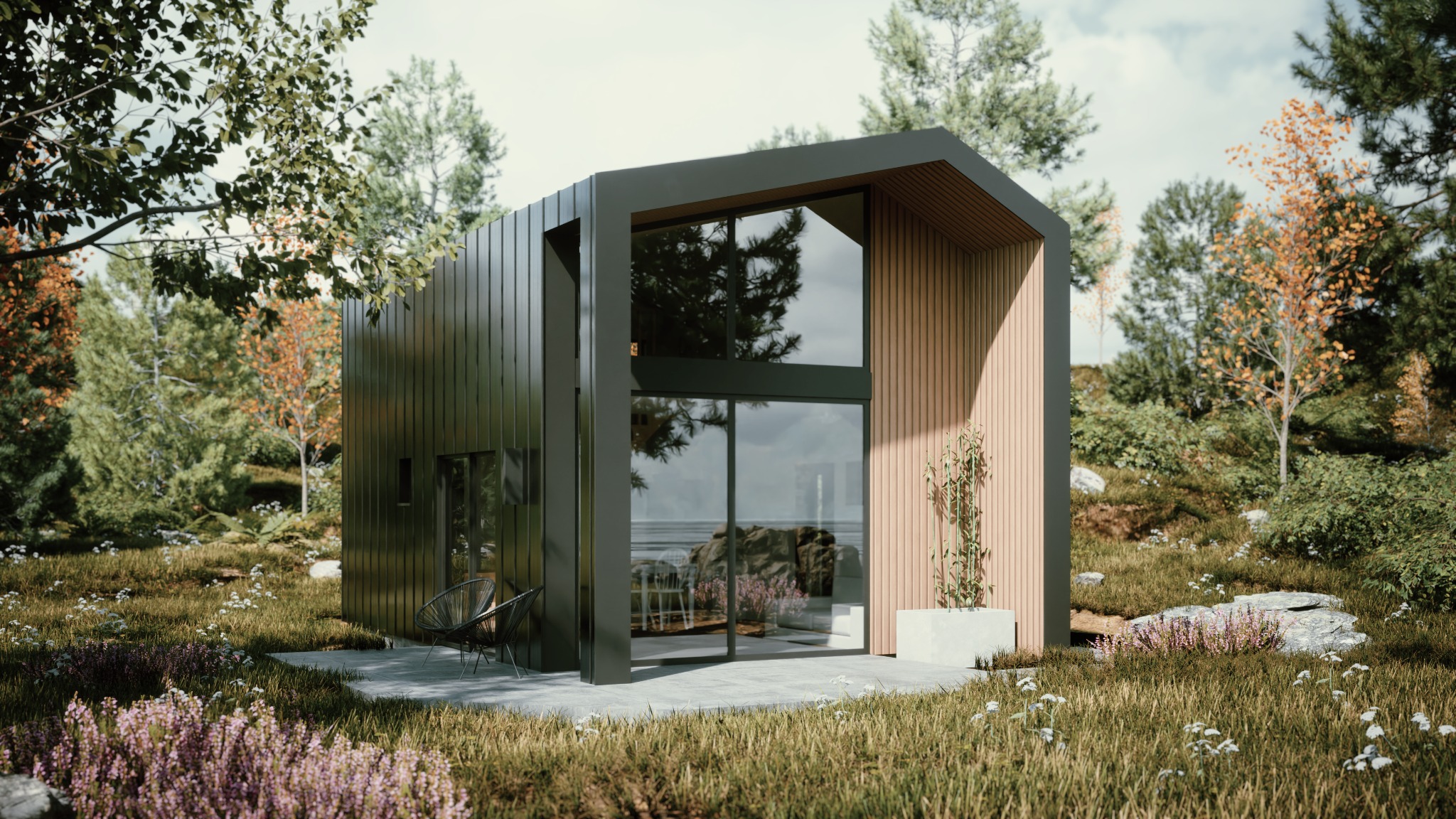 Nowoczesny, minimalistyczny dom z ciemną elewacją i dużymi oknami, otoczony zielenią. Widoczne krzesła na tarasie i roślinność w tle.