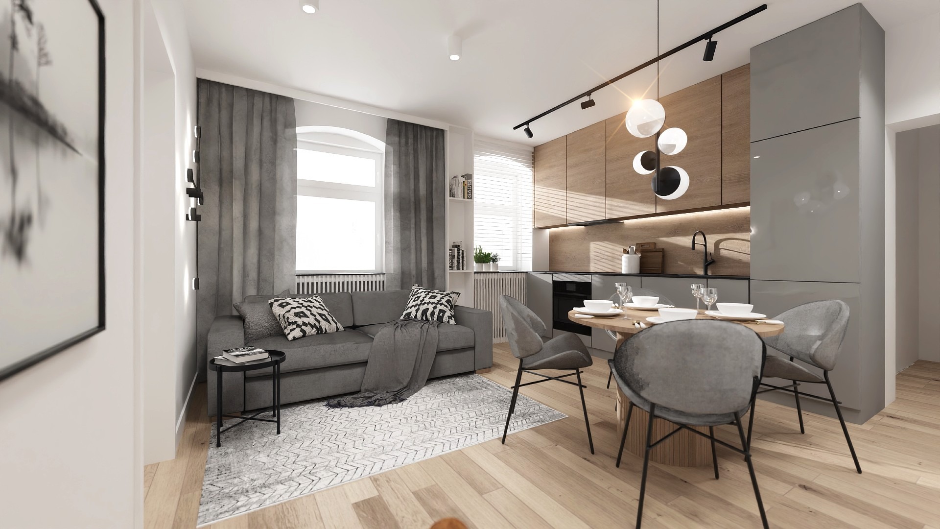 Nowoczesne wnętrze mieszkania w Poznaniu: szara sofa z wzorzystymi poduszkami, okrągły stół z nakryciem, drewniana zabudowa kuchenna i designerska lampa.